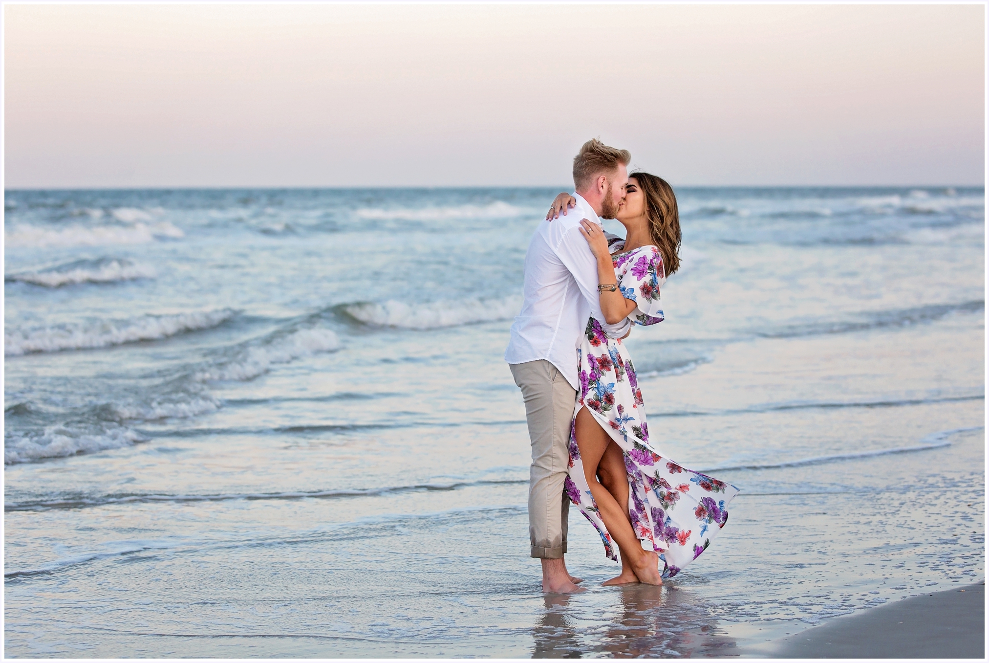 couple standing in the ocean kissing at sunset | Angelface Photography North Florida Engagement Session at Atlantic Beach